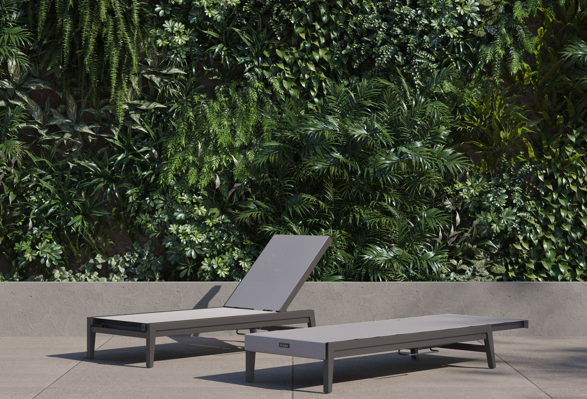Aluminum Outdoor Infinity Chaise Lounge with a gray sling, featuring a sleek frame and adjustable reclining backrest.