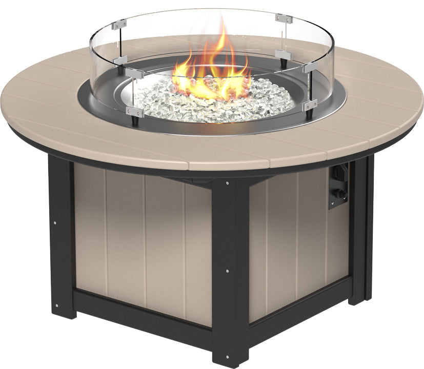 Rectangular fire pit table with a tan top, glass wind guard, and metallic burner, showcasing a vibrant flame.