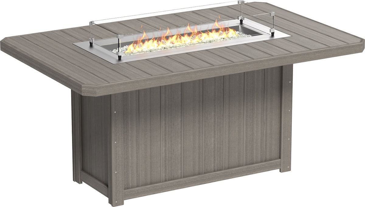 Rectangular counter height fire table in a weathered gray finish, featuring a glass wind guard and stainless steel burner with fire glass.