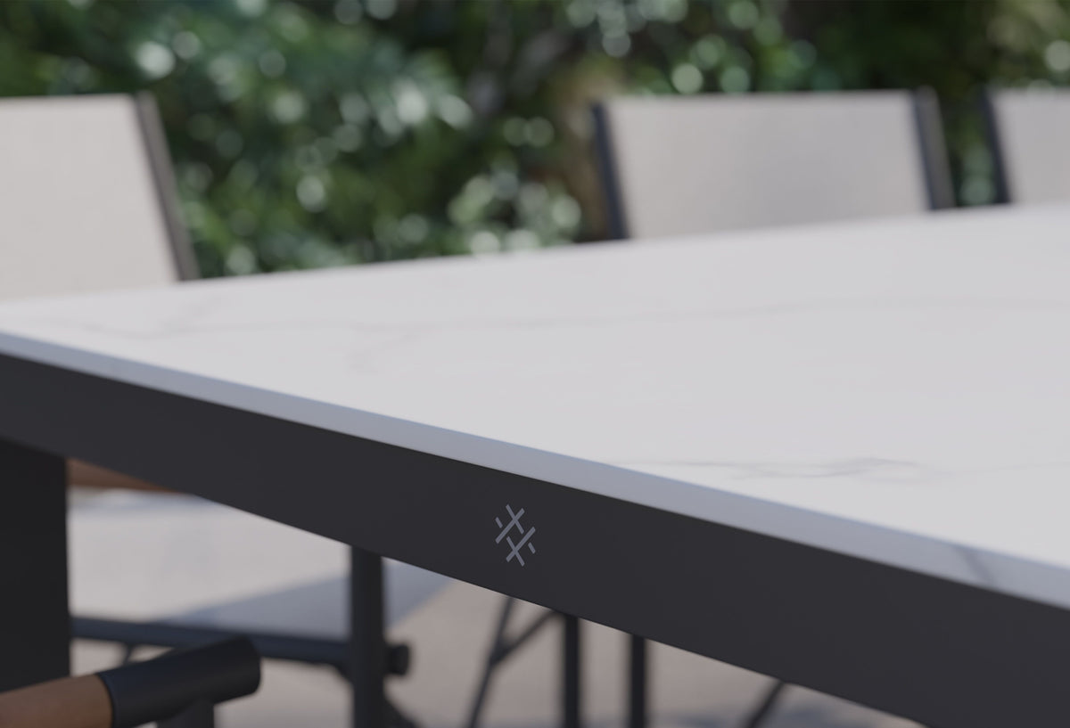 Sintered stone tabletop with a marbled design, paired with powder-coated aluminum frame. Outdoor dining set detail.