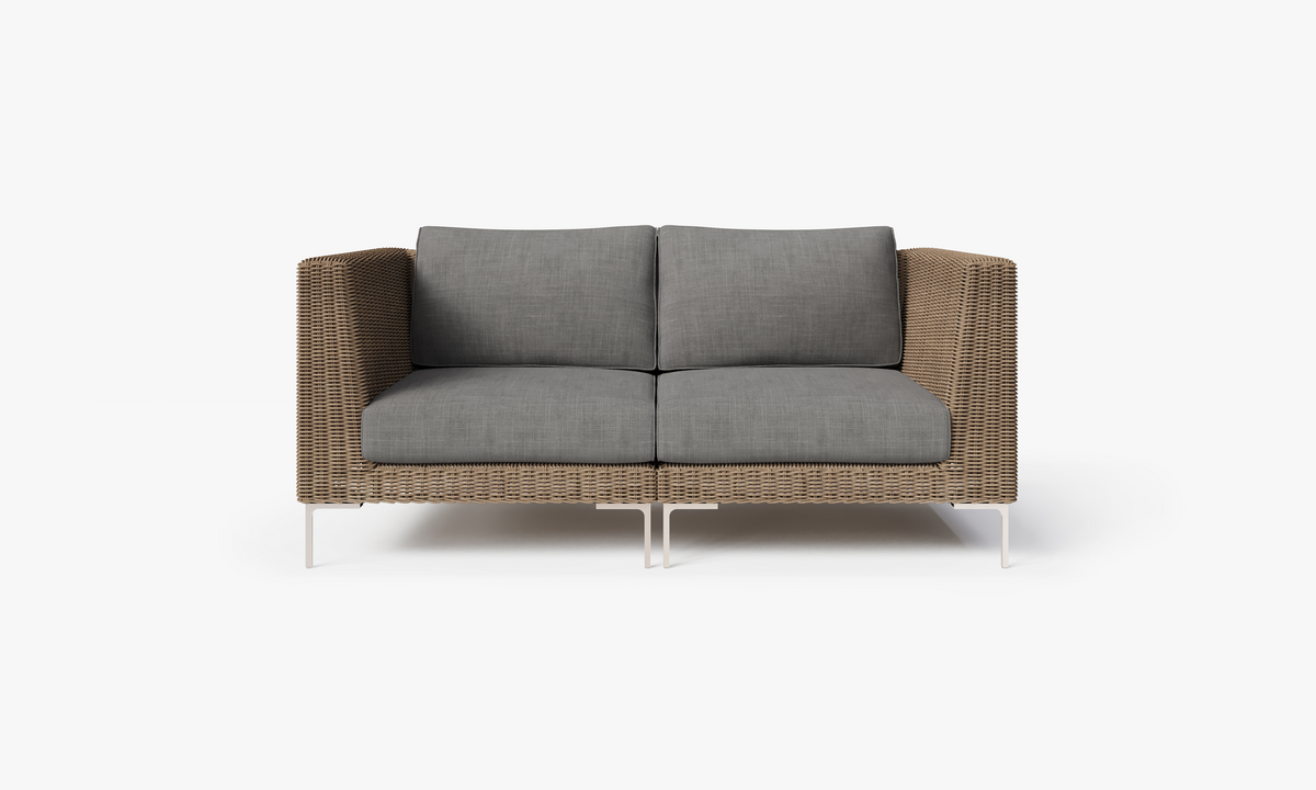 Brown handwoven wicker outdoor loveseat with gray cushions, featuring polished stainless steel legs and a modular design.