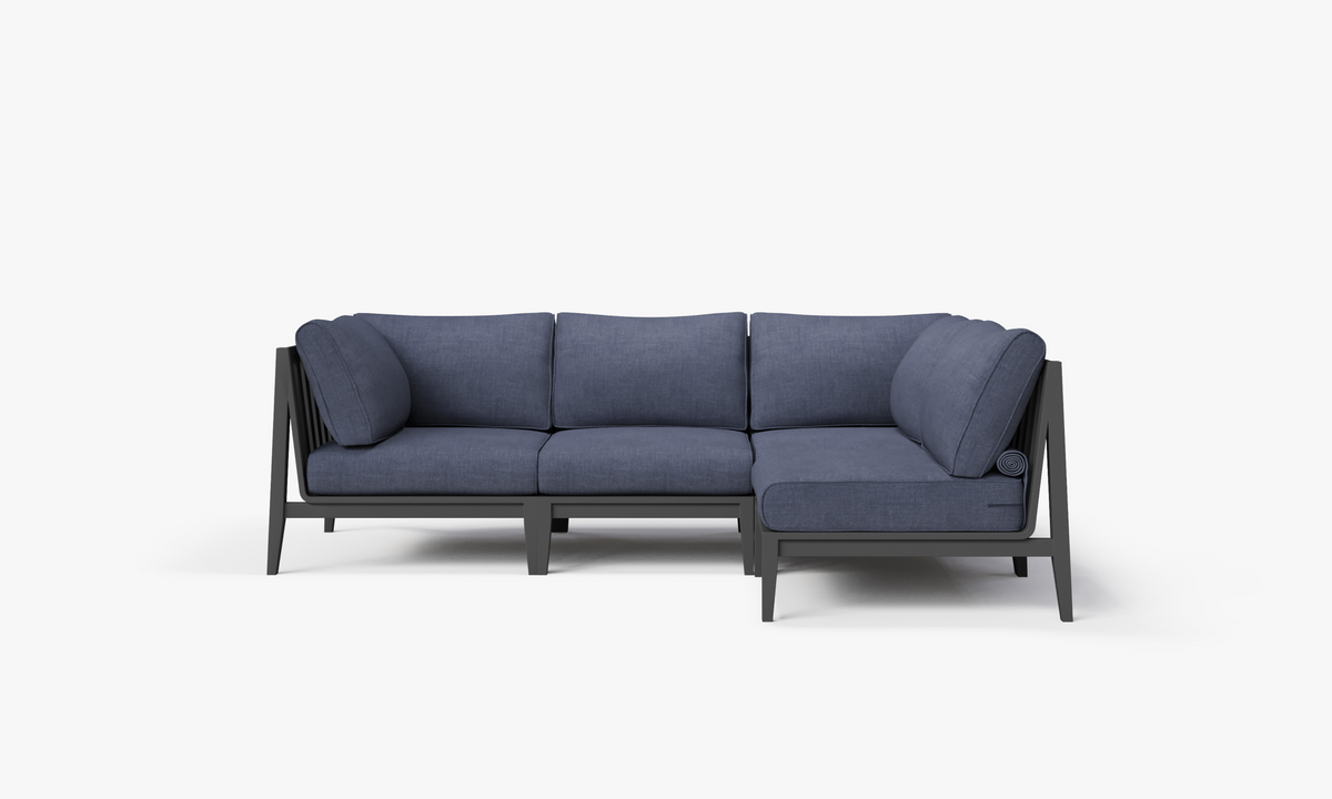 Charcoal aluminum L-shaped sectional with deep sea navy cushions, featuring layered comfort and modern design.