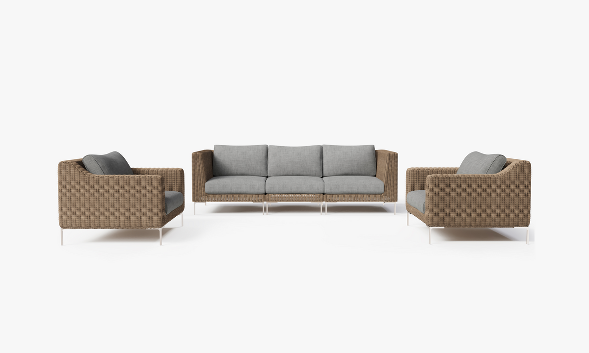 Handwoven brown wicker outdoor sofa with gray cushions, featuring two armchairs and a three-seat sofa in a modular setup.