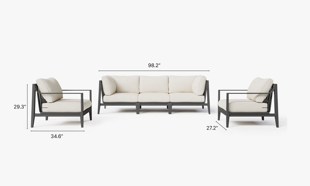 Charcoal aluminum outdoor sofa set includes one armless chair and two armchairs with plush cream cushions and a modular design.