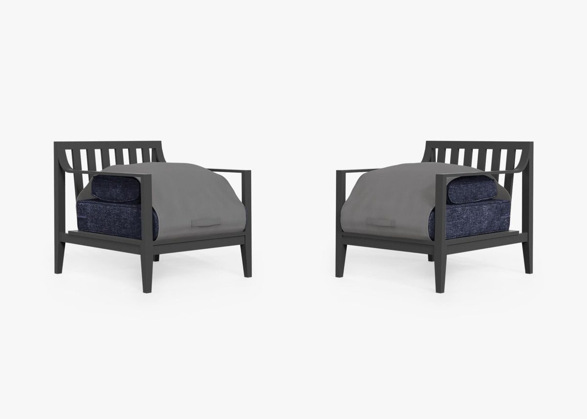 Charcoal aluminum armchair set with plush navy cushions, covered by a gray protective OuterShell®.
