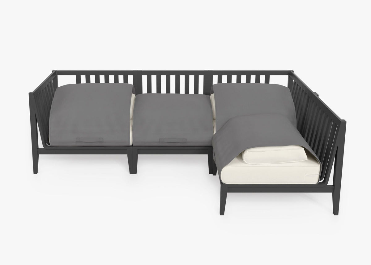 Charcoal aluminum L-shaped outdoor sectional with layered gray cushions, featuring a modular design for four seats.