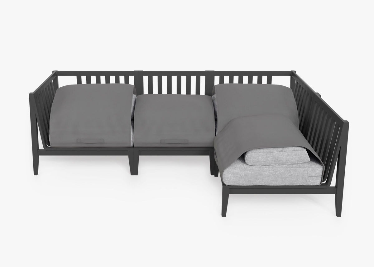 Charcoal aluminum outdoor L-shaped sectional with layered gray cushions, suitable for four, featuring a sleek design.
