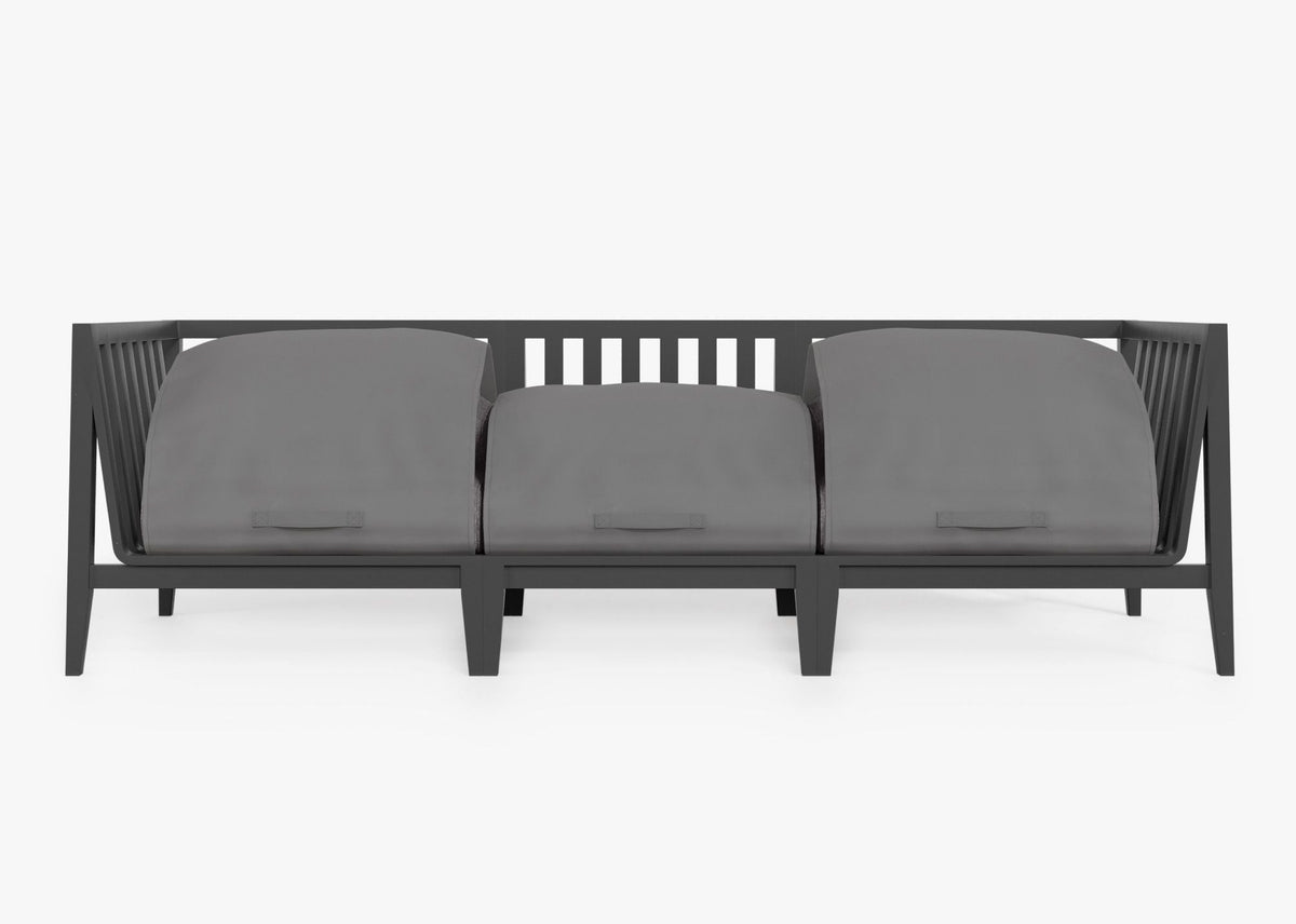 Three-seat outdoor sofa with a charcoal aluminum frame and gray protective cover over layered memory foam cushions.