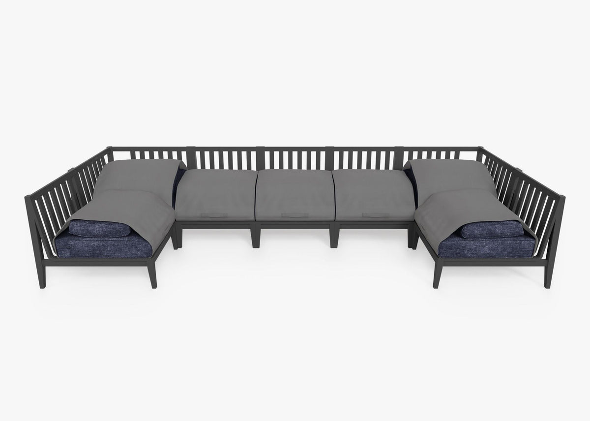 Charcoal aluminum U-shaped sectional with gray weather-resistant covers and layered cushions in blue tones.