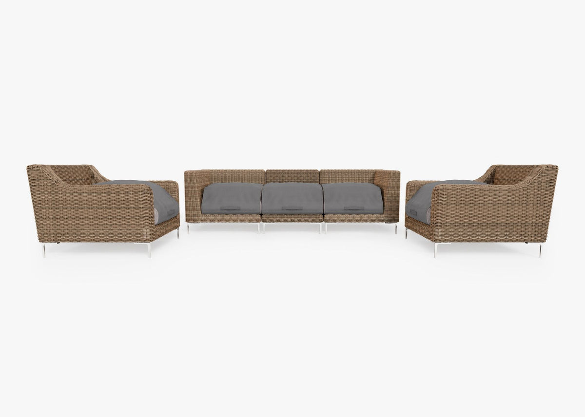 Handwoven brown wicker outdoor sofa set with two armchairs and two corner chairs, featuring gray cushions.
