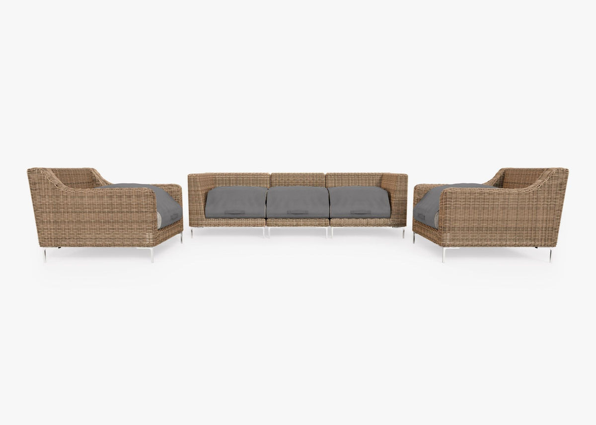 Handwoven brown wicker outdoor sofa set featuring two armchairs and three modular sections, with gray cushions.