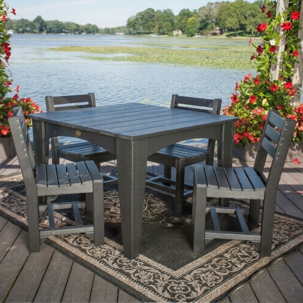 LuxCraft 44" Island Dining Table Set in dark gray, featuring a round table with four matching chairs, shown on a wooden deck.