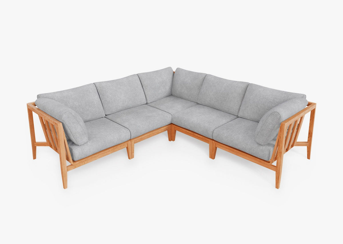 Teak outdoor corner sectional with gray layered cushions, featuring a natural wood frame and modular design for five seats.