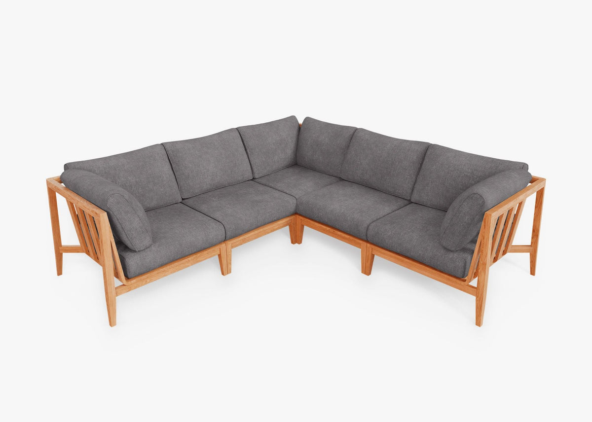 Teak outdoor corner sectional with gray fabric cushions, featuring a modular design and warm wood frame.