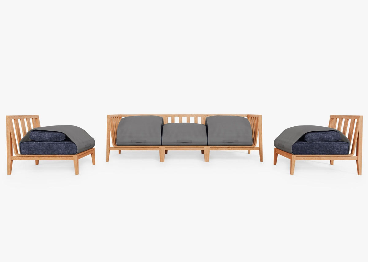 Outer Teak Outdoor Sofa with Armless Chairs features a warm teak wood frame and plush gray cushions protected by a cover.