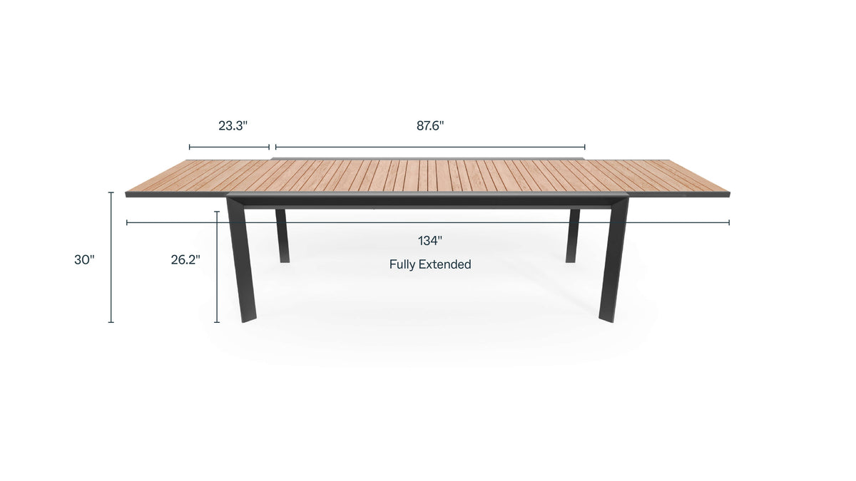 Extendable outdoor dining table with teak wood top and aluminum base, measuring 87.6 inches, expandable to 134 inches.
