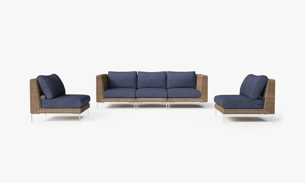 Handwoven brown wicker outdoor sofa with navy cushions, featuring an armless design and modular arrangement for five seats.