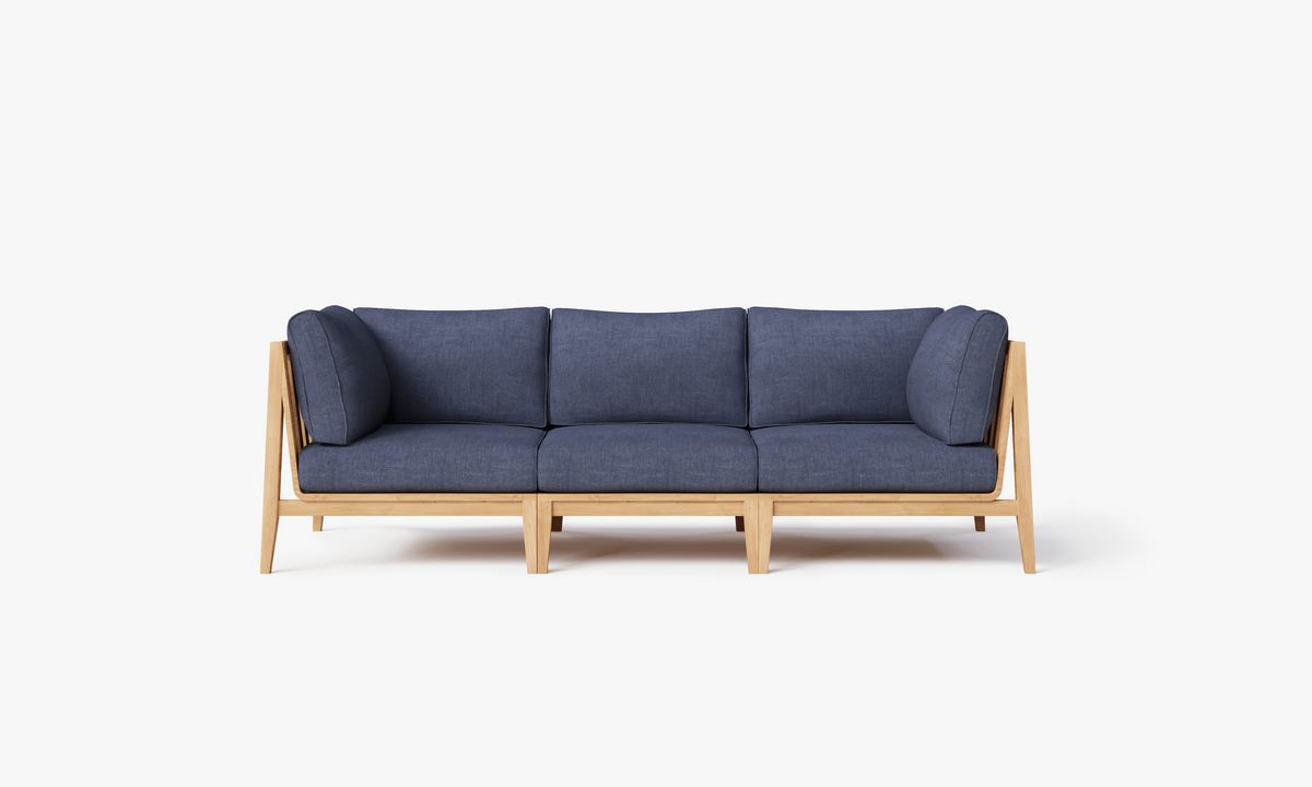 Teak outdoor sofa with a modular design, featuring navy cushions, sleek wood frame, and comfortable layered seating.