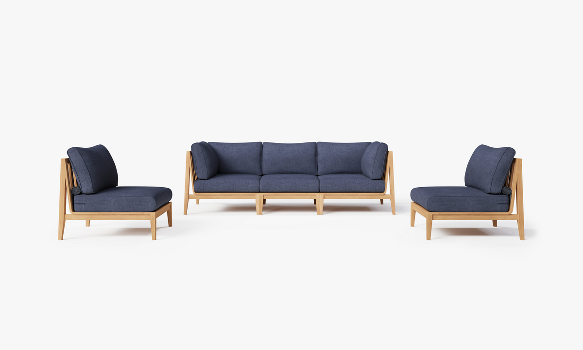 Five-seat outdoor sofa set in navy blue upholstery with plush cushions, featuring armless chairs and natural teak frame.