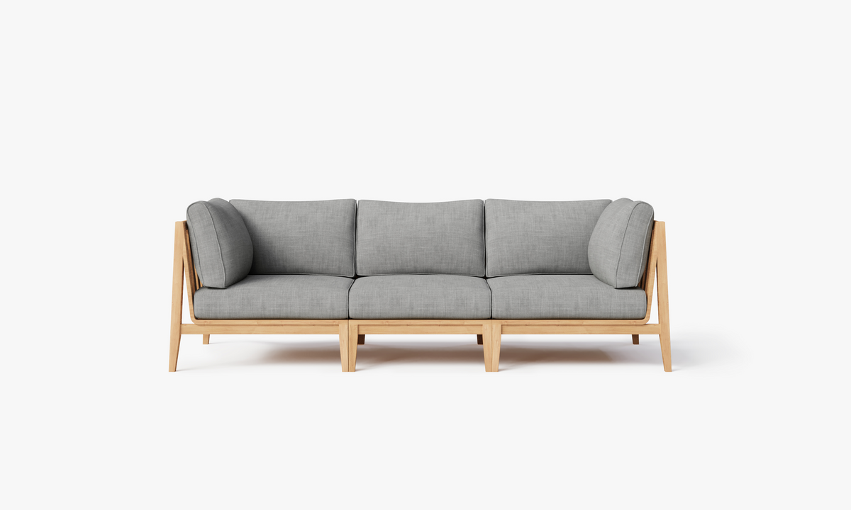 Three-seat outdoor sofa with a light teak frame and soft gray cushions, featuring a modular design for flexible arrangement.