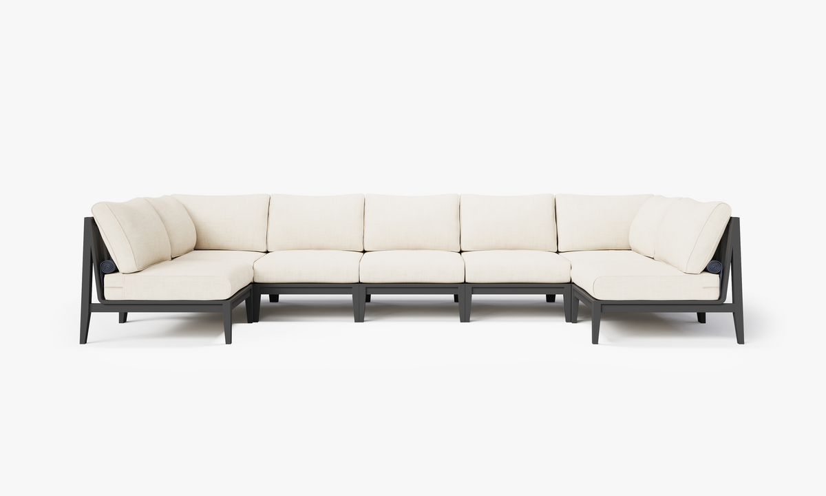 Charcoal aluminum U-shaped sectional sofa with beige layered cushions, designed for seven seats and featuring modular arrangement.