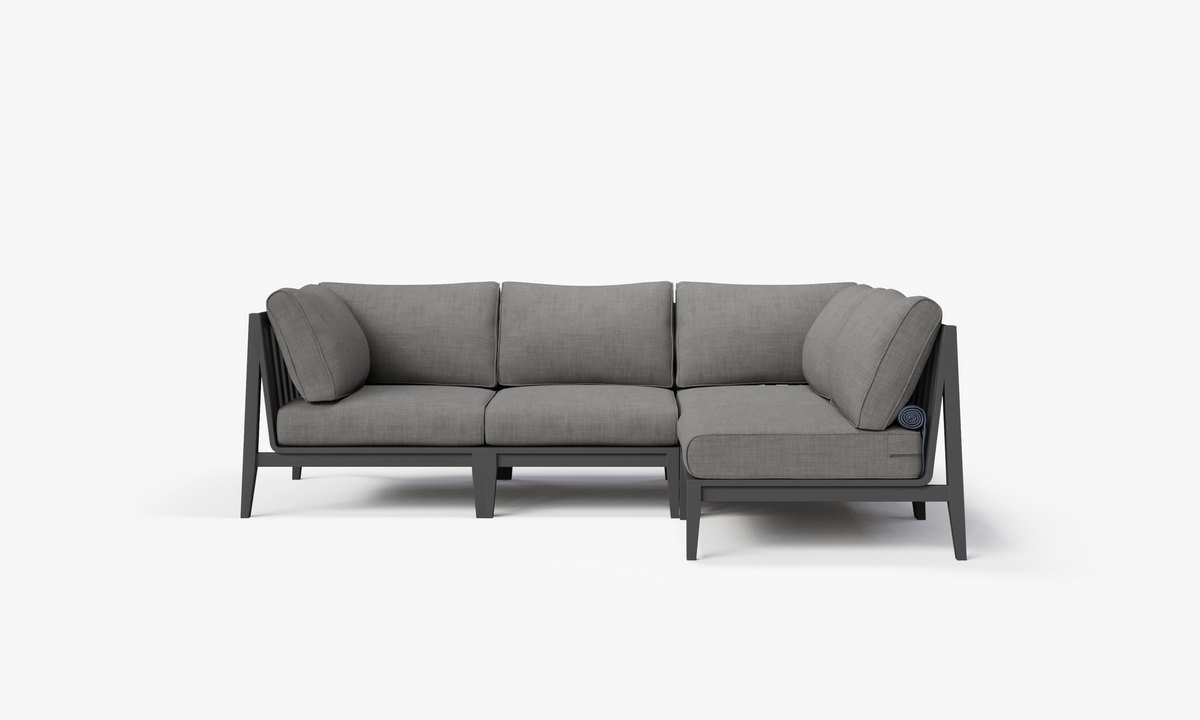 Charcoal aluminum L-shaped sectional with layered gray cushions, designed for four-seat outdoor seating.