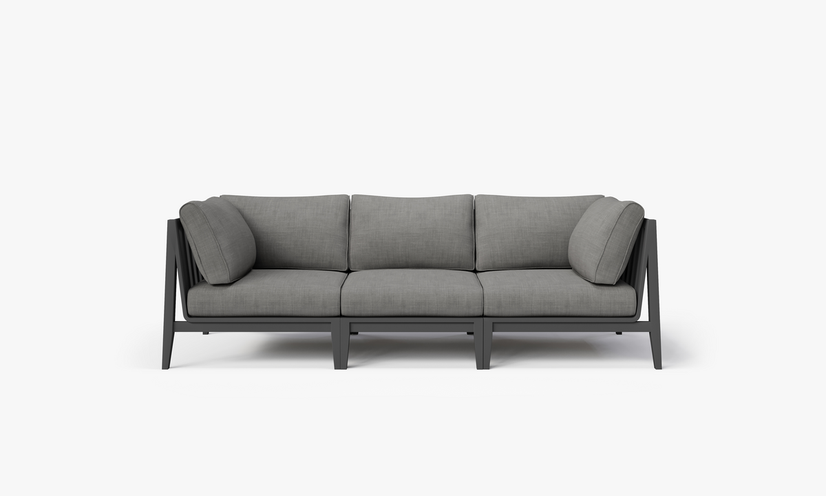 Charcoal three-seat outdoor sofa with layered memory foam cushions and a modern aluminum frame.