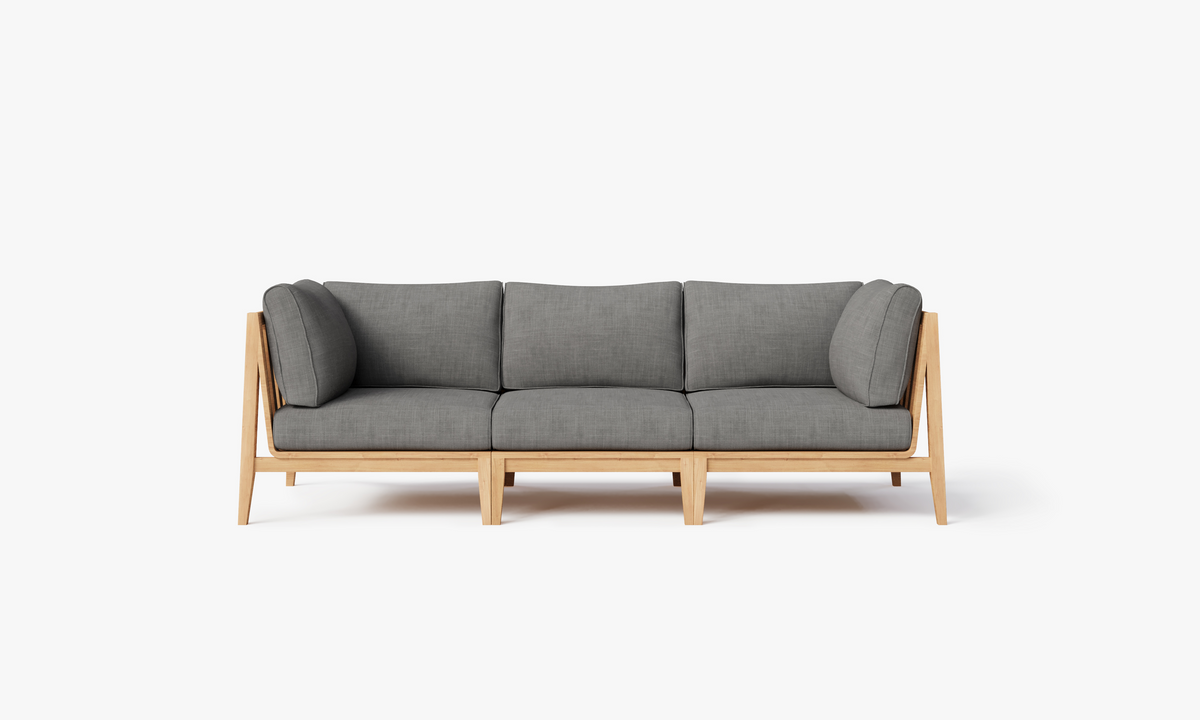 Three-seat outdoor sofa featuring a light teak frame with plush gray cushions. Modular design for flexible arrangement.