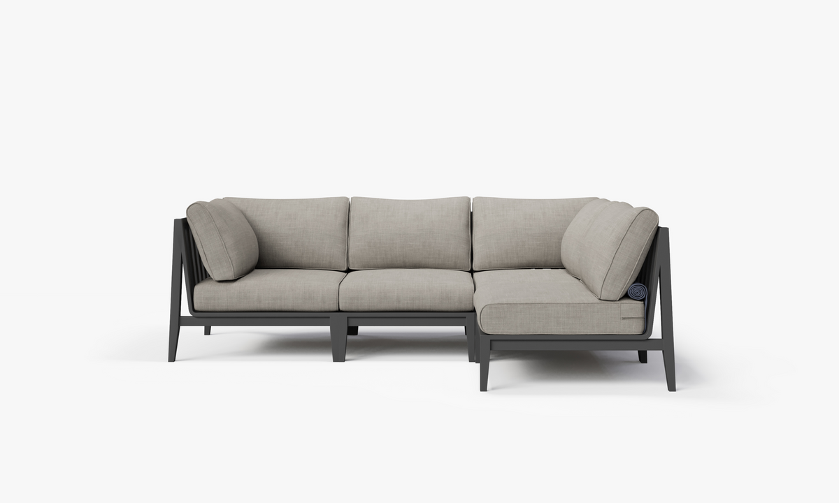 Charcoal aluminum L-shaped outdoor sectional with layered gray cushions and sleek, modern design.