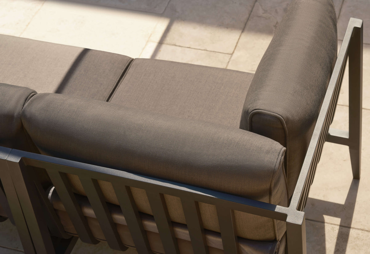 Charcoal aluminum outdoor sofa showing plush multi-layer cushions with a textured fabric and a modular design.