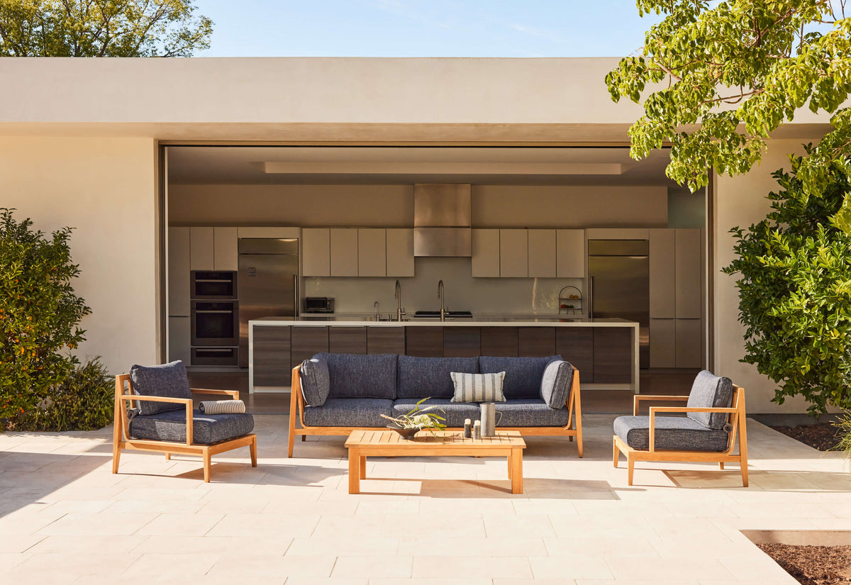 Outer Teak Outdoor U Sectional with a natural wood frame, gray cushions, offering a spacious 7-seat arrangement.